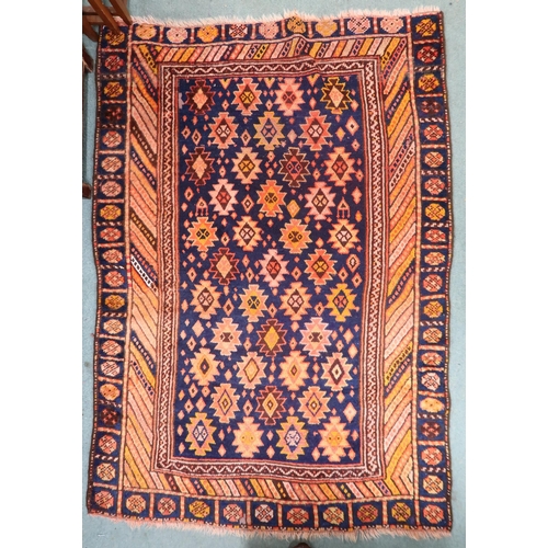 51 - A dark blue ground Persian Qashqai rug with burnt orange geometric pattern within burnt orange borde... 