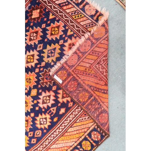 51 - A dark blue ground Persian Qashqai rug with burnt orange geometric pattern within burnt orange borde... 