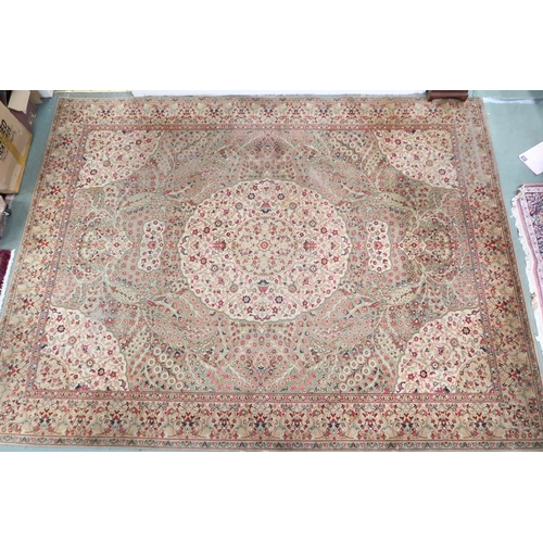 53 - A green ground Templeton style rug with cream central medallion and matching spandrels on floral pat... 