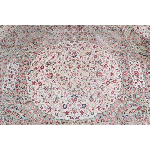 53 - A green ground Templeton style rug with cream central medallion and matching spandrels on floral pat... 