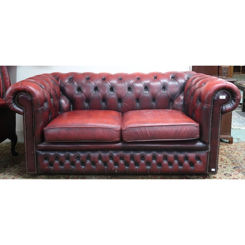 54 - A 20th century oxblood leather upholstered two seater Chesterfield style club sofa, 70cm high x 165c... 