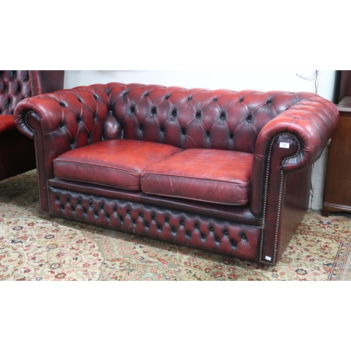 54 - A 20th century oxblood leather upholstered two seater Chesterfield style club sofa, 70cm high x 165c... 