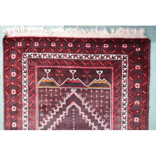 55 - A rich multicoloured ground fine handwoven Afghan Baluch nomadic rug with geometric prayer style cen... 