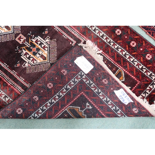 55 - A rich multicoloured ground fine handwoven Afghan Baluch nomadic rug with geometric prayer style cen... 