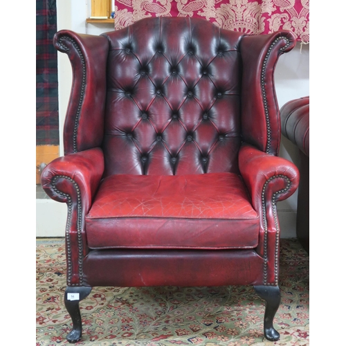 56 - A 20th century oxblood leather upholstered Chesterfield wingback armchair, 118cm high x 93cm wide x ... 