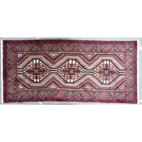 57 - A multicoloured ground fine handwoven Persian Baluchi nomadic rug with geometric patterned ground wi... 