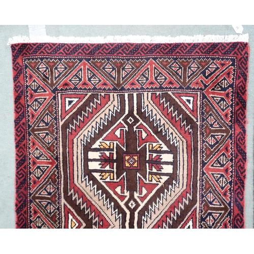 57 - A multicoloured ground fine handwoven Persian Baluchi nomadic rug with geometric patterned ground wi... 