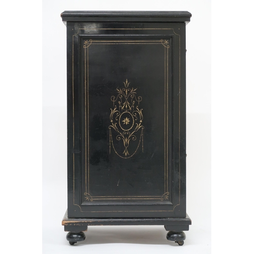 6 - A 19th century continental ebonised music cabinet with single gilt decorated panel door concealing t... 