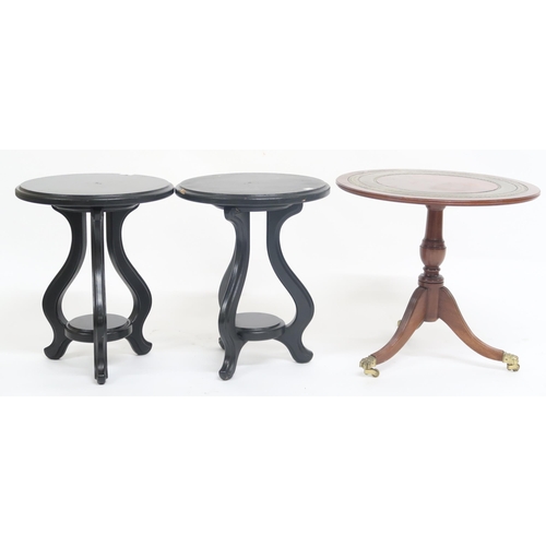 64 - A lot comprising a pair of contemporary ebonised tables with tripod bases and a reproduction circula... 