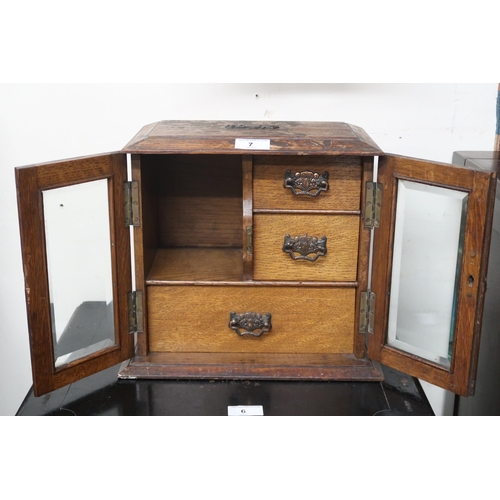 7 - A lot comprising Victorian oak smokers cabinet with pair of glazed doors concealing two short over o... 