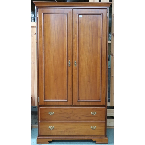 71 - A contemporary Younger two door wardrobe with moulded cornice over pair of doors over two long drawe... 