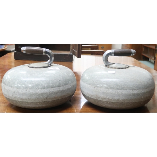 99 - A pair of late 19th/early 20th century polished stone curling stones with metallic and wood handles ... 