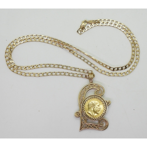 701 - A 1903 gold half sovereign in a 9ct gold filigree Pound sign shaped pendant mount on a 60cm 9ct gold... 