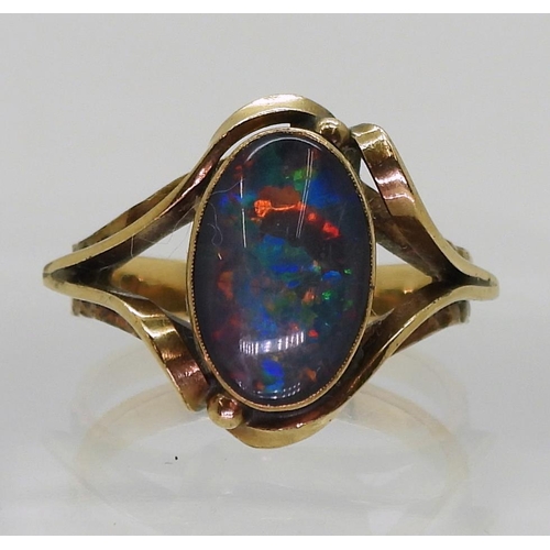 713 - A 10K gold ring set with an opal doublet, size O1/2, weight 4.5gms