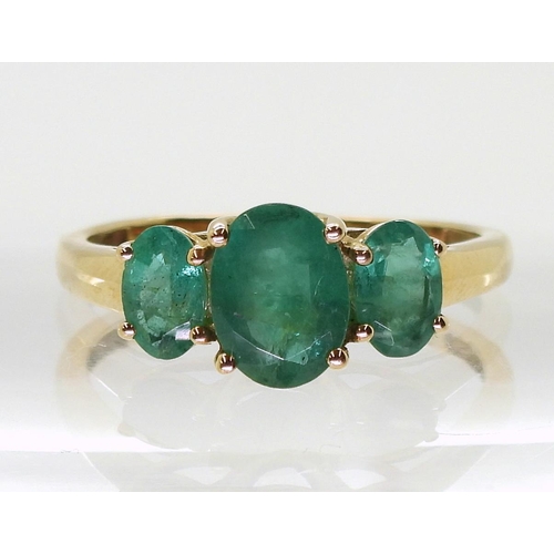 719 - A 9ct gold emerald three stone ring, size T, weight 2.4gms