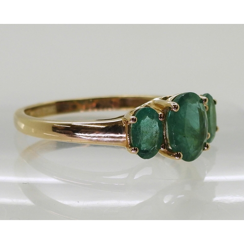 719 - A 9ct gold emerald three stone ring, size T, weight 2.4gms