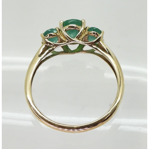 719 - A 9ct gold emerald three stone ring, size T, weight 2.4gms