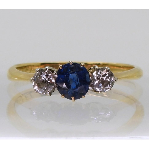 720 - An 18ct gold sapphire and diamond three stone, set with two 0.10ct old cut diamonds flanking an oval... 