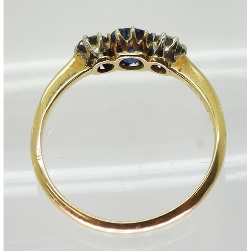 720 - An 18ct gold sapphire and diamond three stone, set with two 0.10ct old cut diamonds flanking an oval... 