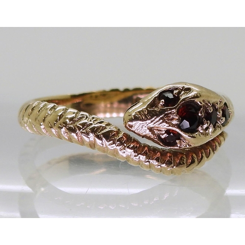 728 - A 9ct gold snake ring, set with garnets, size Q, London 1973 hallmarks  weight 3.9gms