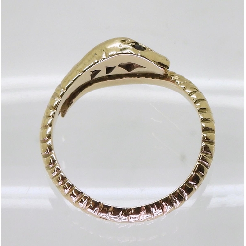 728 - A 9ct gold snake ring, set with garnets, size Q, London 1973 hallmarks  weight 3.9gms