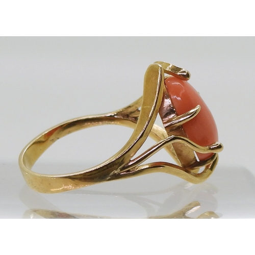 735 - A yellow metal ring set with a coral, size Q, weight 3.8gms