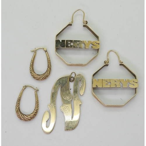 763 - A large pair of yellow metal 'Nerys' earrings, a further pair of creole earrings, and an 'N' pendant... 