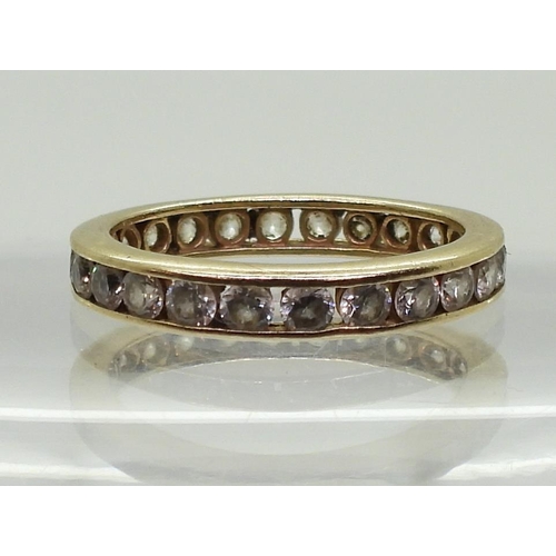 792 - A 14k gold full eternity ring set with cubic zirconia, finger size O, weight 2.8gms