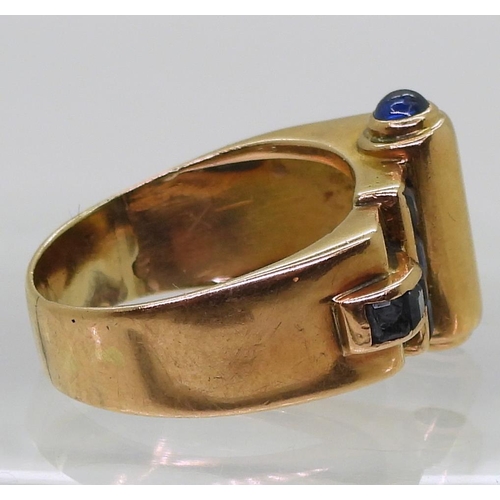 793 - A bright yellow metal Art Deco ring, set with sapphires finger size Q, weight 9.3gms