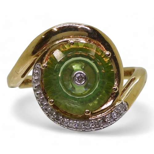 808 - A 9ct gold Glen Lehrer fern green torus ring set with a central diamond and surrounded with a cresce... 