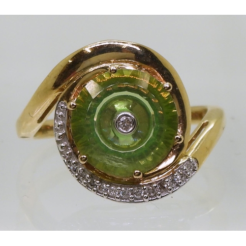 808 - A 9ct gold Glen Lehrer fern green torus ring set with a central diamond and surrounded with a cresce... 