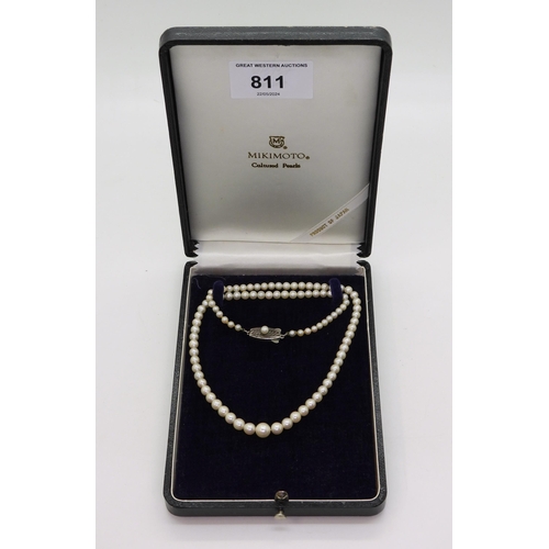 811 - A 46cm string of Mikimoto pearls with silver pearl set Mikimoto branded clasp, in original box large... 