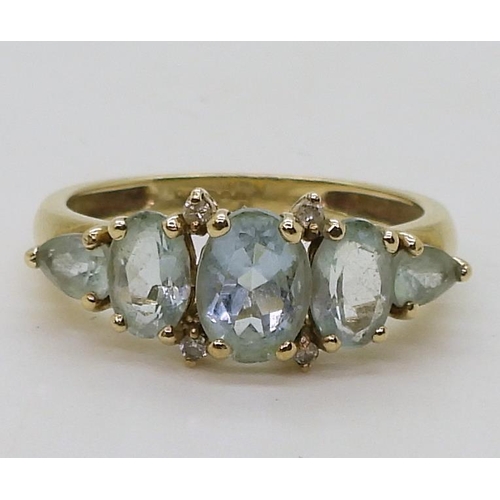 821 - A 9ct gold curb chain bracelet (hollow)18cm, a 9ct gold five stone aquamarine and diamond ring, size... 