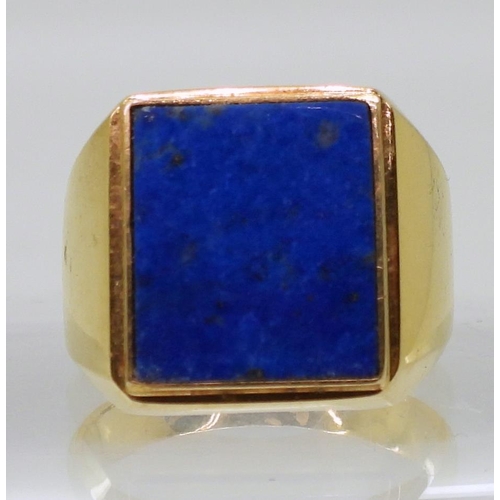 857 - A bright yellow metal lapis lazuli signet ring, stamped 750, finger size S1/2, weight 10.4gms 