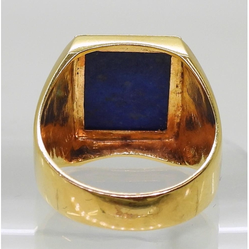 857 - A bright yellow metal lapis lazuli signet ring, stamped 750, finger size S1/2, weight 10.4gms 