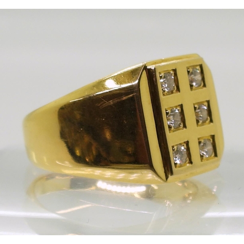 860 - A yellow metal gents signet ring stamped 750, set with six diamonds, with an estimated approx diamon... 