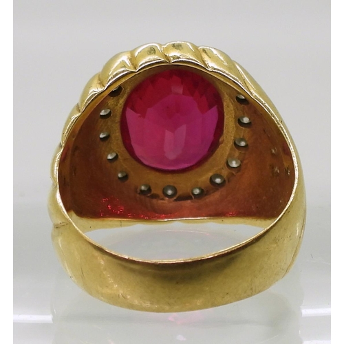 861 - A yellow metal ring, stamped 90%, set with a red gem, and diamonds with an estimated approx diamond ... 