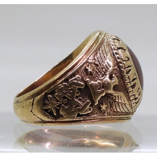 863 - A 10K gold American style college ring set with a red gem, embossed with United States Navy, finger ... 