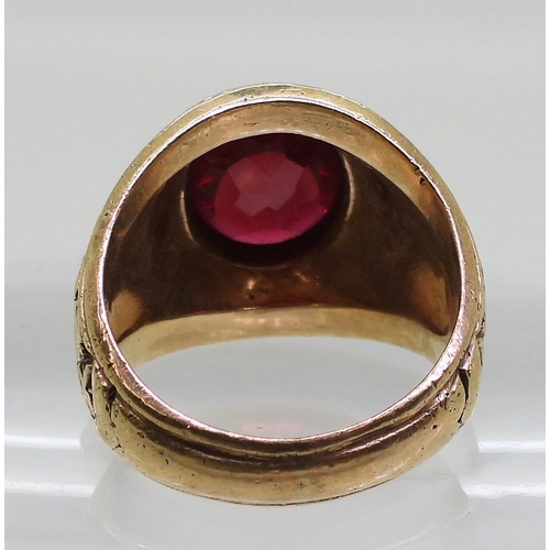 863 - A 10K gold American style college ring set with a red gem, embossed with United States Navy, finger ... 