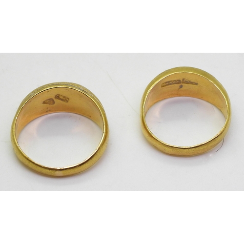 868 - Two bright yellow metal rings, with star engraved pattern, sizes Q, and P, one stamped with Chinese ... 