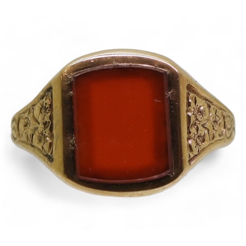 869 - A 9ct gold carnelian signet ring, the shoulders engraved with flowers, finger size W, weight 6.9gms