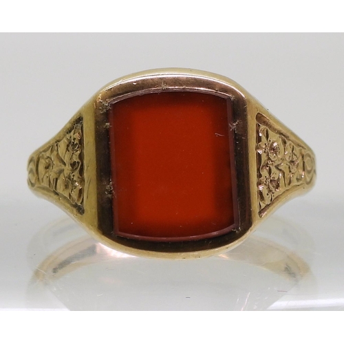 869 - A 9ct gold carnelian signet ring, the shoulders engraved with flowers, finger size W, weight 6.9gms