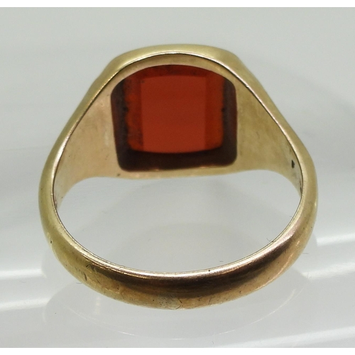 869 - A 9ct gold carnelian signet ring, the shoulders engraved with flowers, finger size W, weight 6.9gms