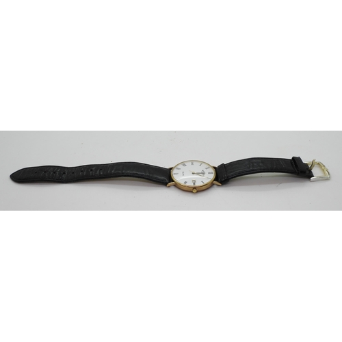 874 - A 9ct gold Rotary Elite watch, with black leather strap, weight 24.6gms