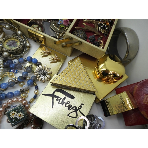 900 - A large collection of vintage costume jewellery and compacts to include a triangular Faberge compact... 