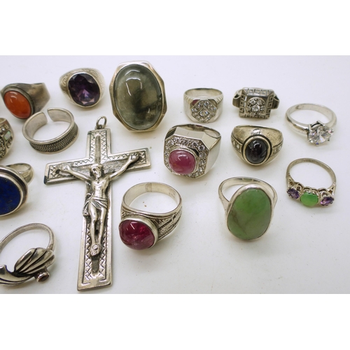 919 - A large white metal crucifix, and a collection of silver and white metal rings to include rutilated ... 