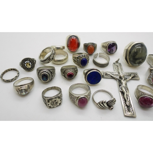 919 - A large white metal crucifix, and a collection of silver and white metal rings to include rutilated ... 