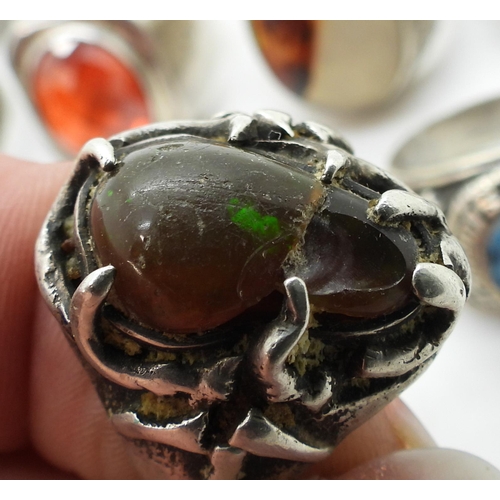 929 - A collection of silver and white metal gem set rings to include ruby-zoisite, agate, turquoise, opal... 