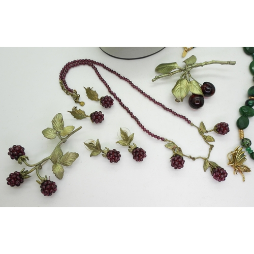 933 - A necklace, brooch and two pairs of garnet 'blackberry', earrings, a cherry brooch , a Pia multi gem... 