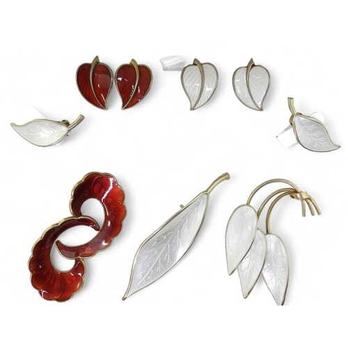 941 - A collection of silver gilt  Norwegian enamel jewellery to include a white leaf brooch and earrings ... 